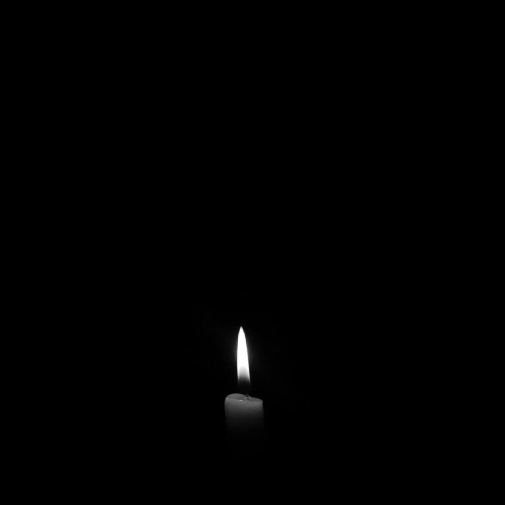 Candle Lighting up a Dark Room